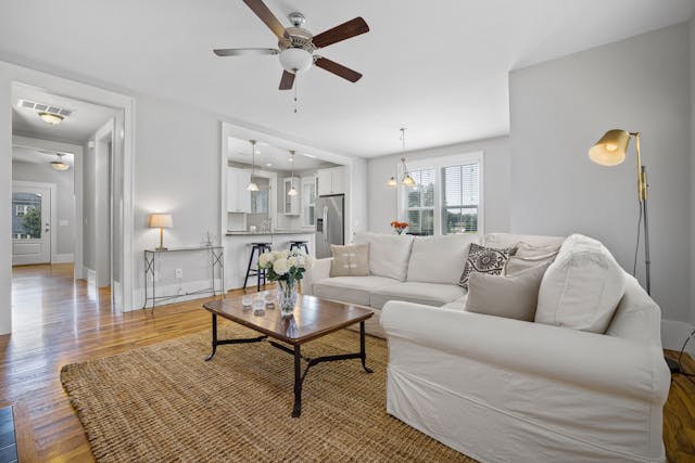 Furnished living room with a couch, table, and lamp.